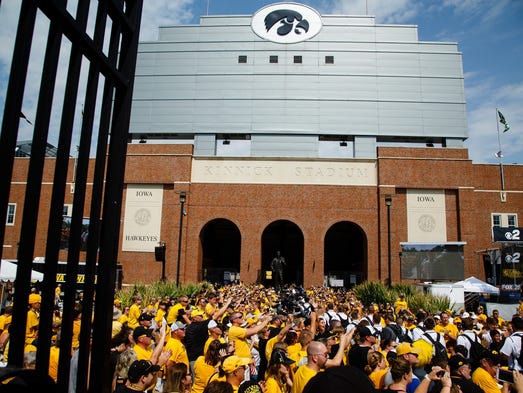 Players walk through fans before Iowa takes on North