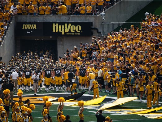 The Hawkeyes enter the stadium before their football