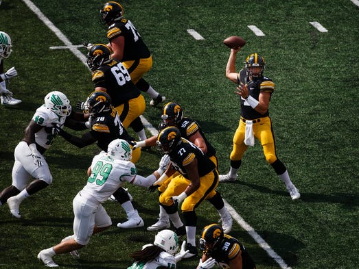 Iowa's Nate Stanley (4) passes the ball during their