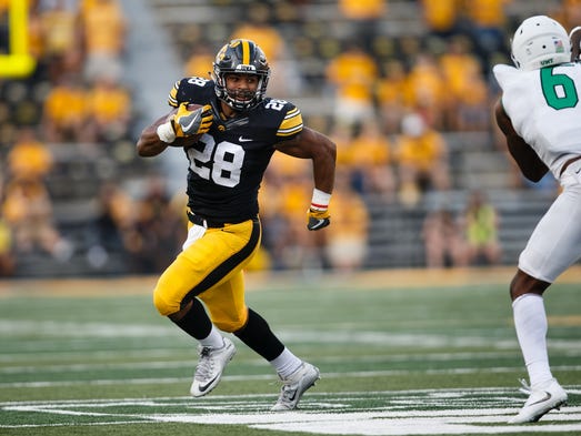 Iowa's Toren Young (28) rushes during their football