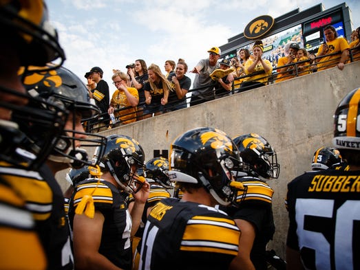 The Hawkeyes walk off the field following their football