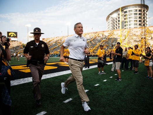 Iowa head coach Kirk Ferentz runs off the field after