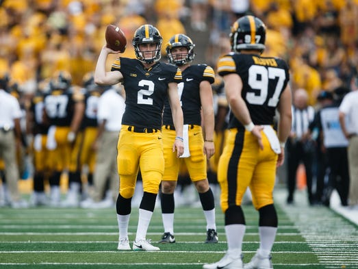 Iowa's Ryan Gersonde (2) warms up between plays during