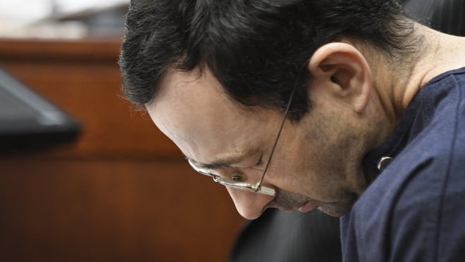 Larry Nassar hangs his head as former gymnast Amanda Thomashow gives her victim statement Tuesday, Jan. 23, 2018,  in Ingham County Circuit Court in Lansing, Michigan.