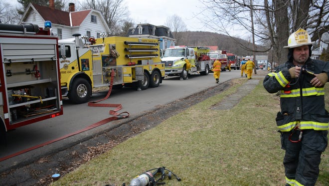 Officials on the scene of a house fire in Windsor Sunday.