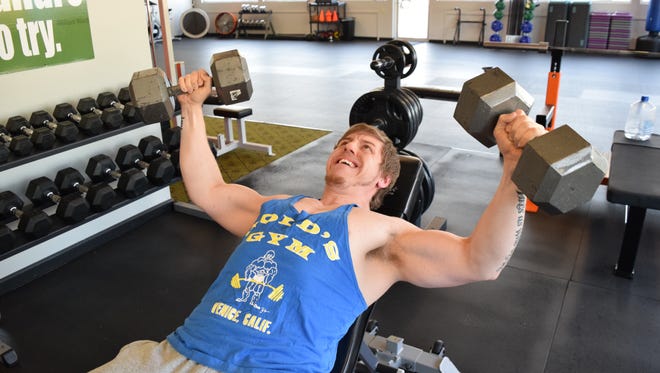 Josh Greer does inclined dumbbell flies. He started seriously working out five years ago, dropping over 100 pounds along the way. Greer will compete in a body building competition in Columbus in October.