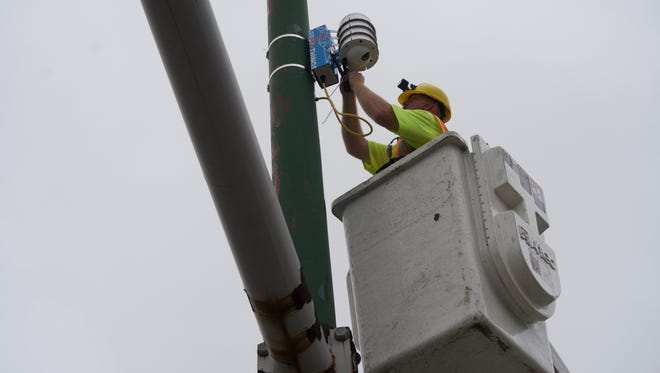 Nick Stodony, a Chicago Department of Transportation lineman, on Thursday, Aug. 25, 2016,  installs one of the first two modular sensor boxes that are part of Chicago's Array of Things project. The city, in partnership with the University of Chicago and Argonne National Laboratory, will install 500 sensor boxes throughout the city that will provide real-time data to the public about air quality and traffic on a block-by-block basis.