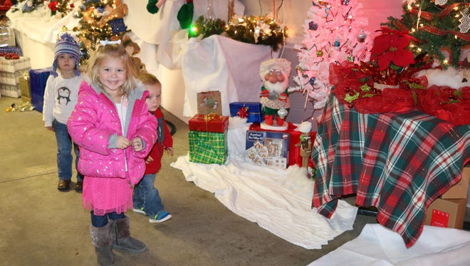 From left: Ava Lowe, 2, Ellee Miller, 4, and Jay Miller, 2, explore Winter Wonderland during Winesburg Christmas Weekend in Clyde.