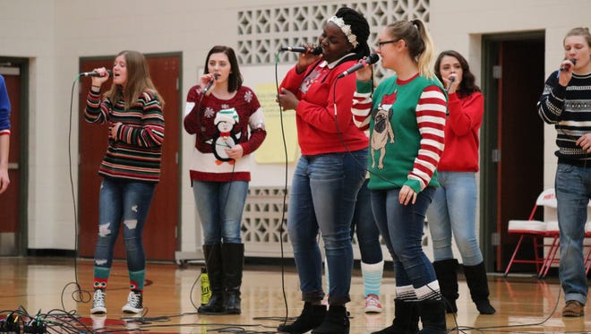 Touch of Class members Cin'ara Hicks and Laura Helmer perform a duet during their Christmas show at Port Clinton Middle School.