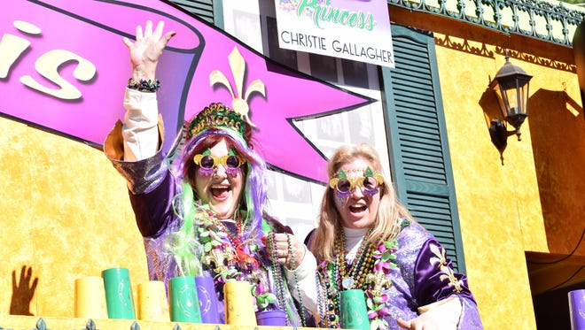 Krewe of Fleur de Lis members wave to parade-goers at the 23rd annual krewes parade Sunday in Alexandria. (2016)