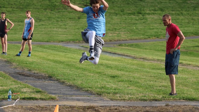Tyler Cowan competes in the long jump.