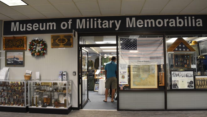 Visitors marvel at historical items found at the Museum of Military Memorabilia at the Naples Municipal Airport on April 29, 2017. The Naples Police Department is investigating a report of grand theft at the museum.