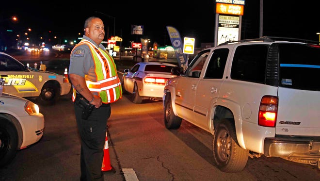 Officers conduct a DUI checkpoint on US Highway 41A near the Tennessee/Kentucky state line on Friday.
