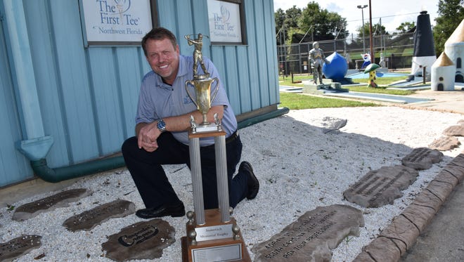 Marty Stanovich with the Stan Stanovich Trophy which honored his father's contributions to junior golf and became the name for the overall boys champion winner of the Divot Derby. The event celebrates its 60th anniversary tournament this week.