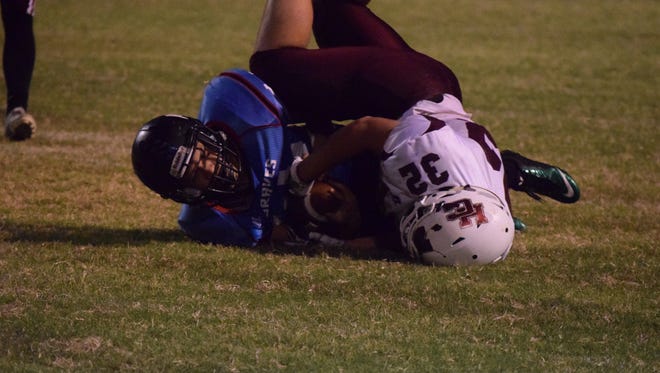 x holds on to the ball as he lands on the ground during the game last Thursday night.