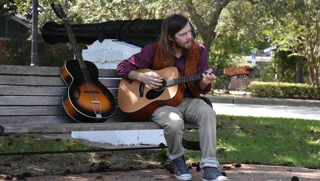Local musician Joshua Tyrone plays his guitar on Monday, Oct. 9, at Lee Square.