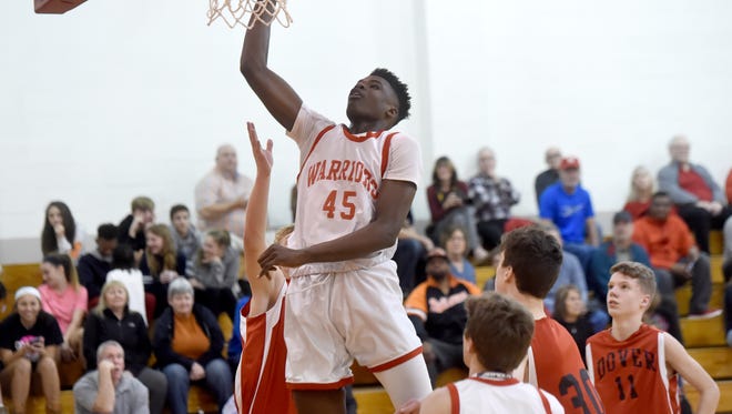 Jarace Walker, 14, soars above his teammates at Susquehannock and ninth grade opponents of Dover High School during a recent game in the auxiliary gym of Susquehannock high school. 