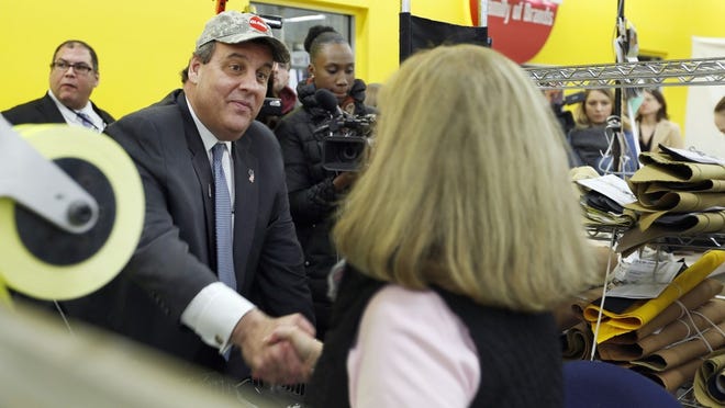 Republican presidential candidate, New Jersey Gov. Chris Christie, R-N.J., shakes hands with Judy Brown during a campaign stop at Globe Manufacturing, a family owned business that makes suits for firefighters, Thursday, Jan. 21, 2016, in Pittsfield, N.H (AP Photo/Jim Cole)