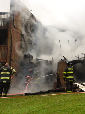 Firefighters battle a blaze at The Arbors in the Town of Hyde Park on May 4.