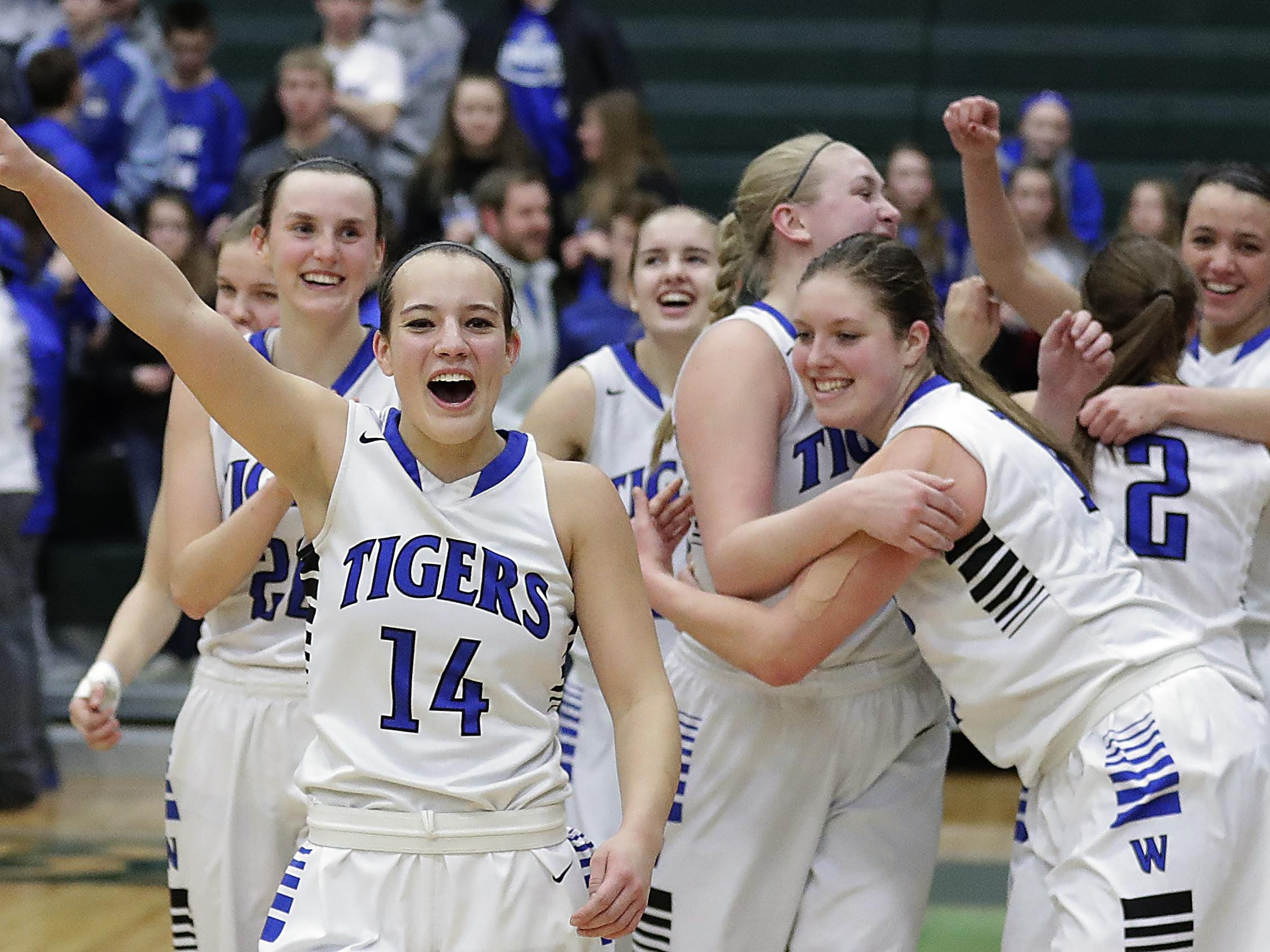 Wrightstown guard Alisha Murphy (14) leads the celebration after the Tigers defeated Amherst to advance to the WIAA Division 3 girls basketball state tournament. See more photos from Saturday’s sectional final at greenbaypressgazette.com.