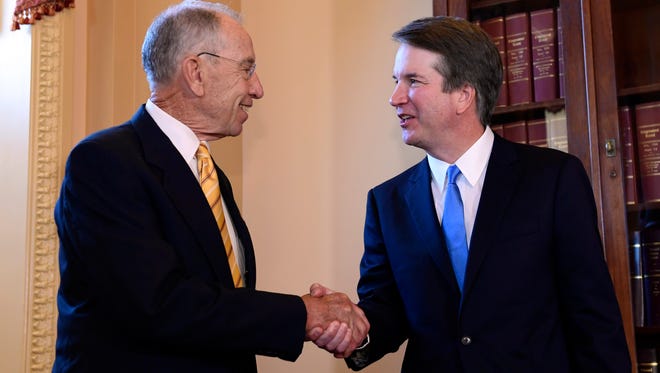 Supreme Court nominee Brett Kavanaugh, right, shakes hands with Sen. Chuck Grassley, R-Ia., left, on Capitol Hill in Washington, Tuesday, July 10, 2018.