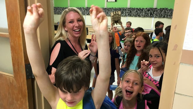 Second grade teacher Kristen Orians says goodbye to students on the last day of school at R.C. Waters Elementary School.