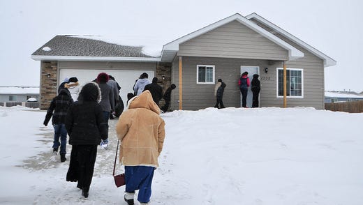 People arrive for the block party home dedications on Jan. 19.