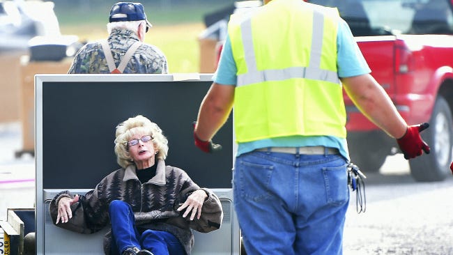 Wilda Shoop, Shippensburg, is carted in, along with an old TV, to Southampton Township's regional electronic recycling collection event on Saturday. Shoop was not, however, left with the old monitors, keyboards and other electronics.