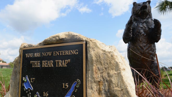 A sign and statue of a bear to mark the three holes known as the Bear Trap prior to the start of the Honda Classic.