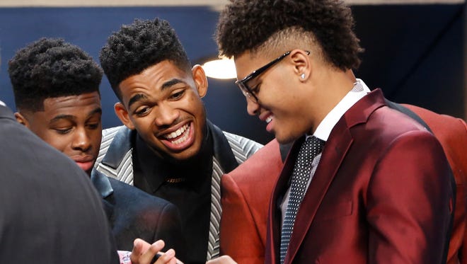 From left, NBA draft prospects Emmanuel Mudiay, Karl-Anthony Towns and Kelly Oubre Jr. talk during a photo op before the NBA basketball draft, Thursday, June 25, 2015, in New York. (AP Photo/Kathy Willens) 