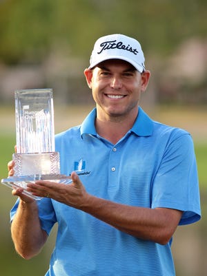 Repeat winner Bill Haas holds the trophy after winning the 2015 Humana Challenge on Sunday, January 25, 2015 at the Palmer Private Course at PGA West in La Quinta, Calif. Haas started the day in a four-way tie for the lead and shot a 67 in the final round for the win.