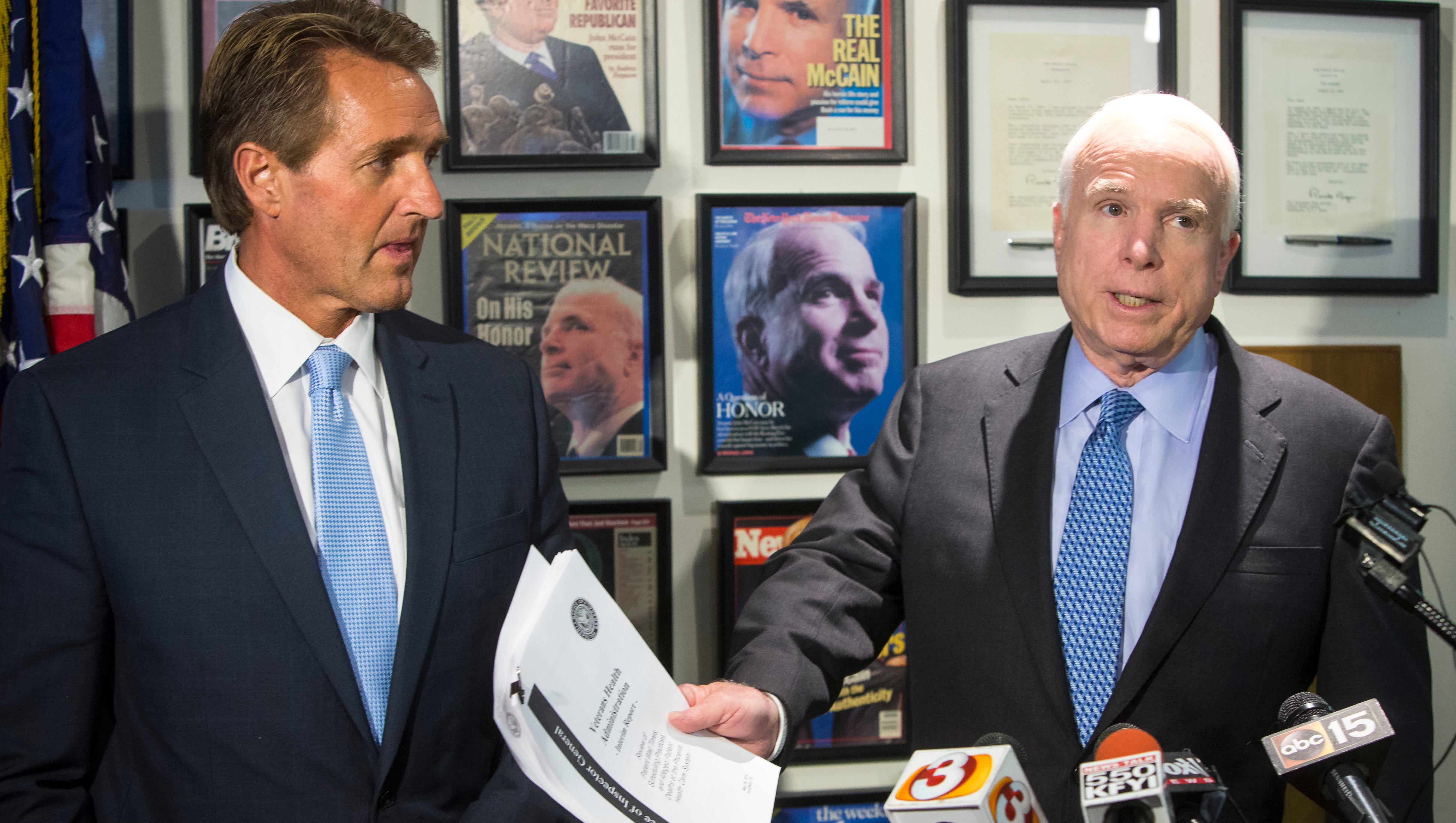 Sens. John McCain and Jeff Flake address members of