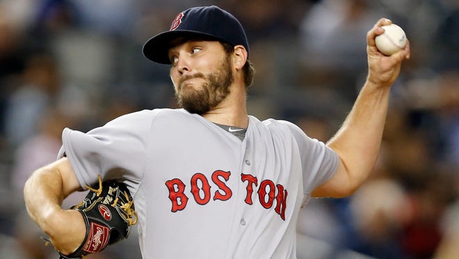 Boston Red Sox starting pitcher Wade Miley delivers in the first inning of a baseball game against the New York Yankees,  in New York. The Seattle Mariners have obtained left-hander Wade Miley and reliever Jonathan Aro from the Boston Red Sox for reliever Carson Smith and pitcher Roenis Elias, Monday, Dec. 7, 2015.