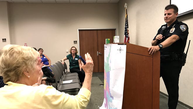 Sue Lang, a downtown neighborhood resident, asks Redding Police Chief Roger Moore a question during a Neighborhood Watch meeting at the Redding library on Tuesday evening.