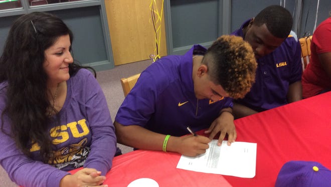 Pineville senior Keelyn Johnson (center) signs with LSU Friday.