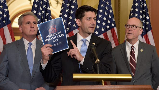 House Speaker Paul Ryan of Wis., center, standing with Energy and Commerce Committee Chairman Greg Walden, R-Ore., right, and House Majority Whip Kevin McCarthy, R-Calif., left, speaks during a news conference on the American Health Care Act on Capitol Hill in Washington, Tuesday, March 7, 2017.