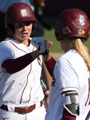 FSU’s Cali Harrod, left, is congratulated by teammate Carsyn Gordon  after scoring a run against LSU during the first game of their Super Regional matchup at JoAnne Graf Field on Friday, May 26, 2017.