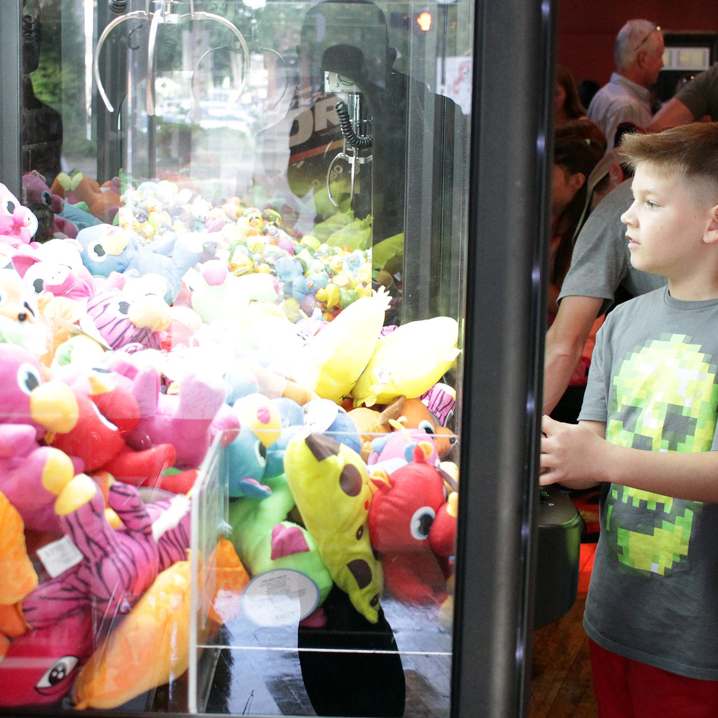 A couple boys try their luck on the claw machine in the game room at Fillys restaurant in Gallatin , TN on Thursday June 21, 2018.  Photo by Dave Cardaciotto 