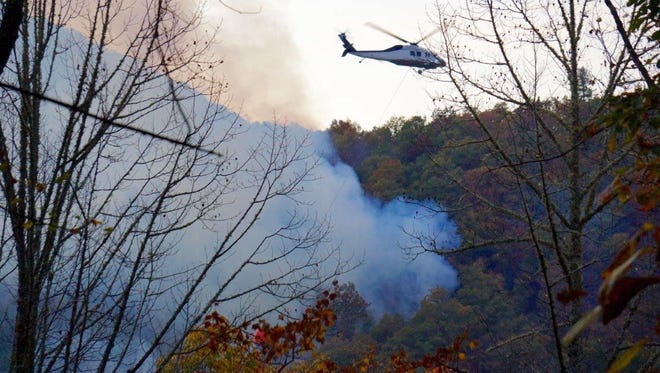 A helicopter drops retardant on the Moses Creek Fire in October. Unusually dry and warm conditions have led to multiple fires in the Nantalahala National Forest.
