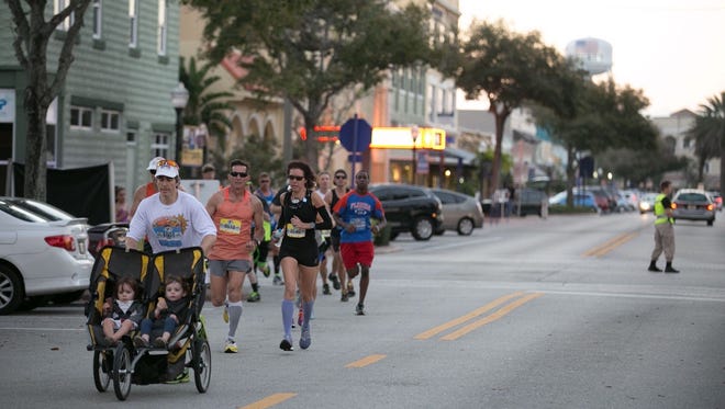 Marathon participants fill the streets of downtown Stuart- some even pushing a stroller as they race against the clock