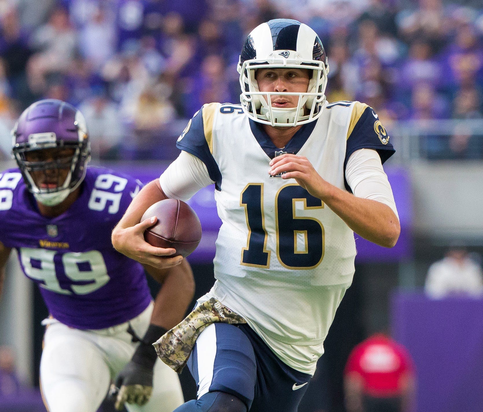 Los Angeles Rams quarterback Jared Goff (16) scrambles in the second quarter against the Minnesota Vikings at U.S. Bank Stadium.
