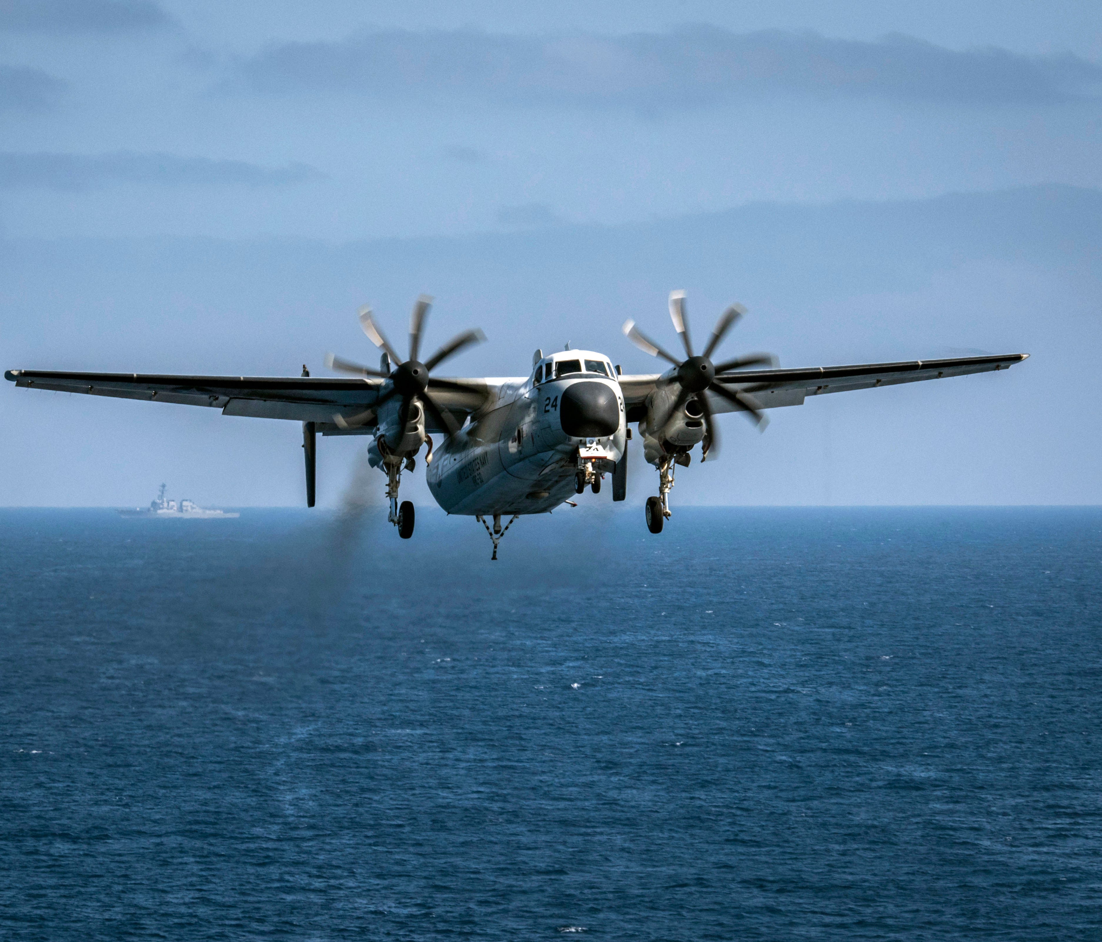 In this image provided by the U.S. Navy, a C-2A Greyhound assigned to the Providers of Fleet Logistics Support Squadron (VRC) 30, prepares to land on the flight deck aboard the aircraft carrier USS Theodore Roosevelt (CVN 71) on Aug. 22, 2017. The se