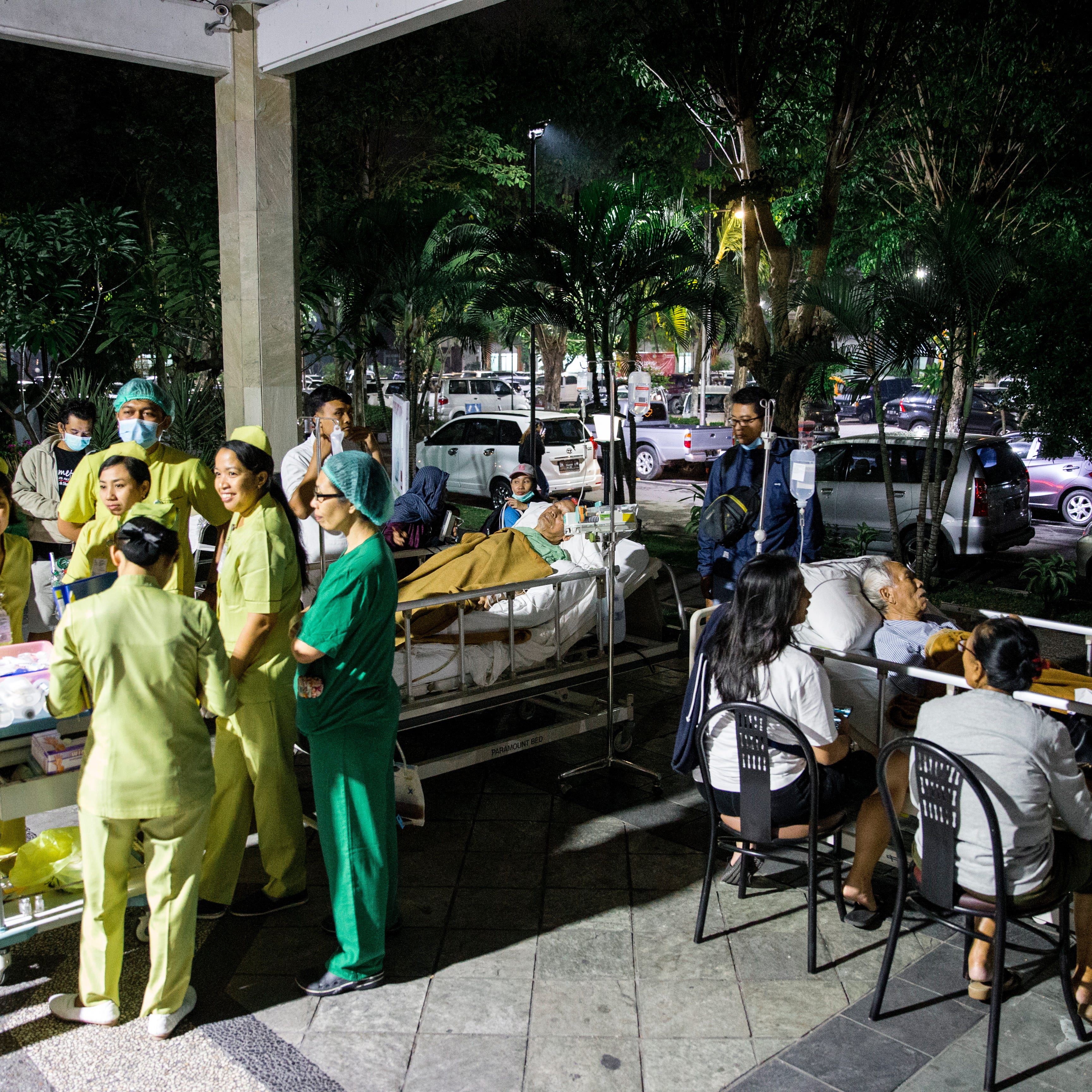 Hospital patients are moved outside of the hospital building after an earthquake was felt in Denpasar, Bali, Indonesia on Aug. 5, 2018. Reports state that the magnitude 7.0 earthquake was centered on the Indonesian island of Lombok nearby of Bali.