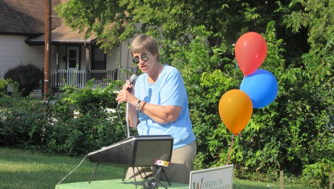 Sister Barbara Busch, executive director of Working In Neighborhoods, addresses a crowd in College Hill Sept. 8.