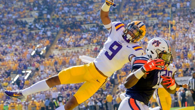 LSU safety Grant Delpit (9) prevents Auburn wide receiver Eli Stove (12) from scoring a touchdown in the first half of an NCAA college football game in Baton Rouge, La., Saturday, Oct. 14, 2017. (AP Photo/Matthew Hinton)