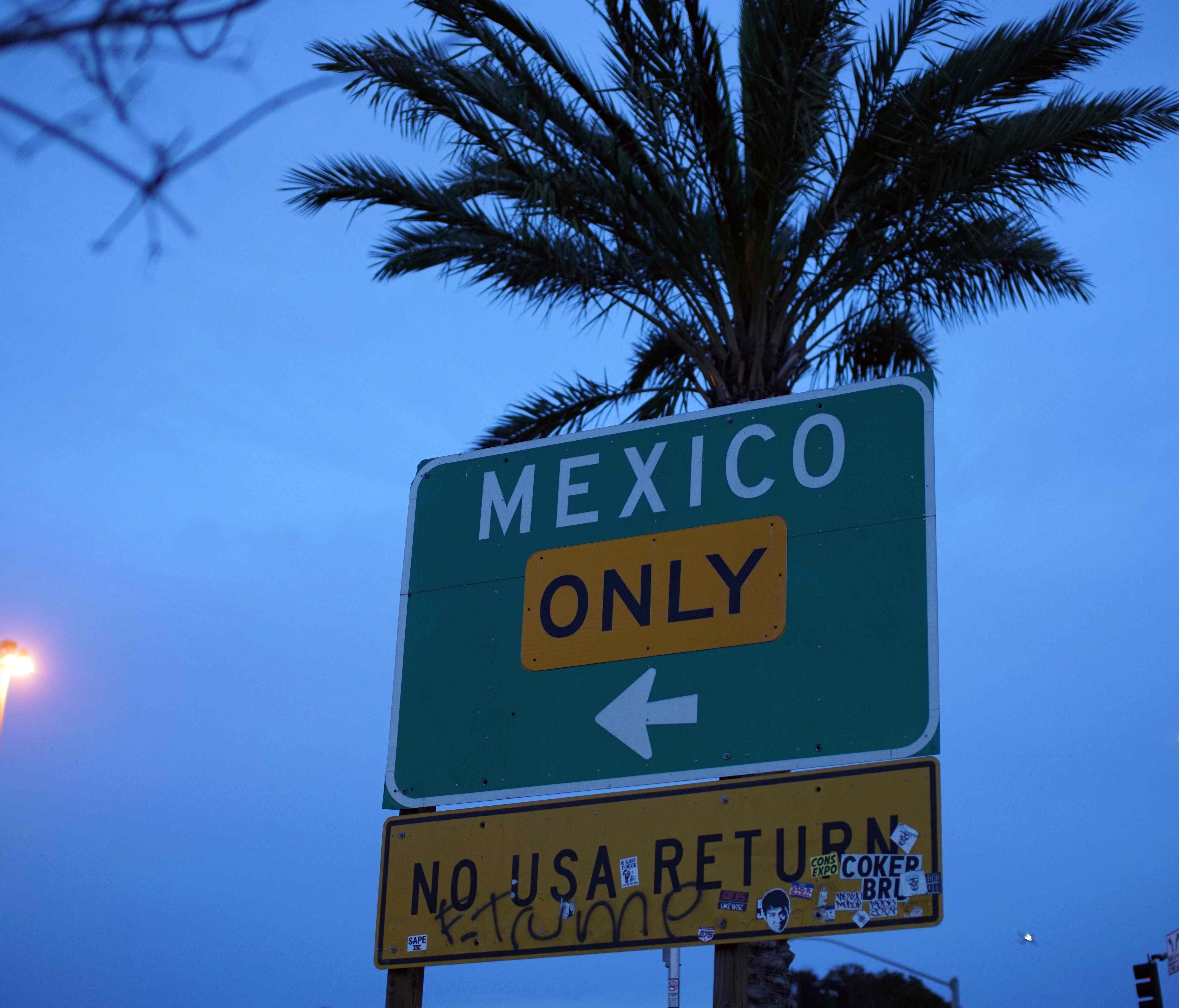 A street sign leading into Mexico at the U.S.-Mexico Border wall near the San Ysidro port of entry in San Ysidro, Calif., on Feb. 10, 2017.