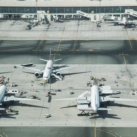 Planes parked at a busy airport.