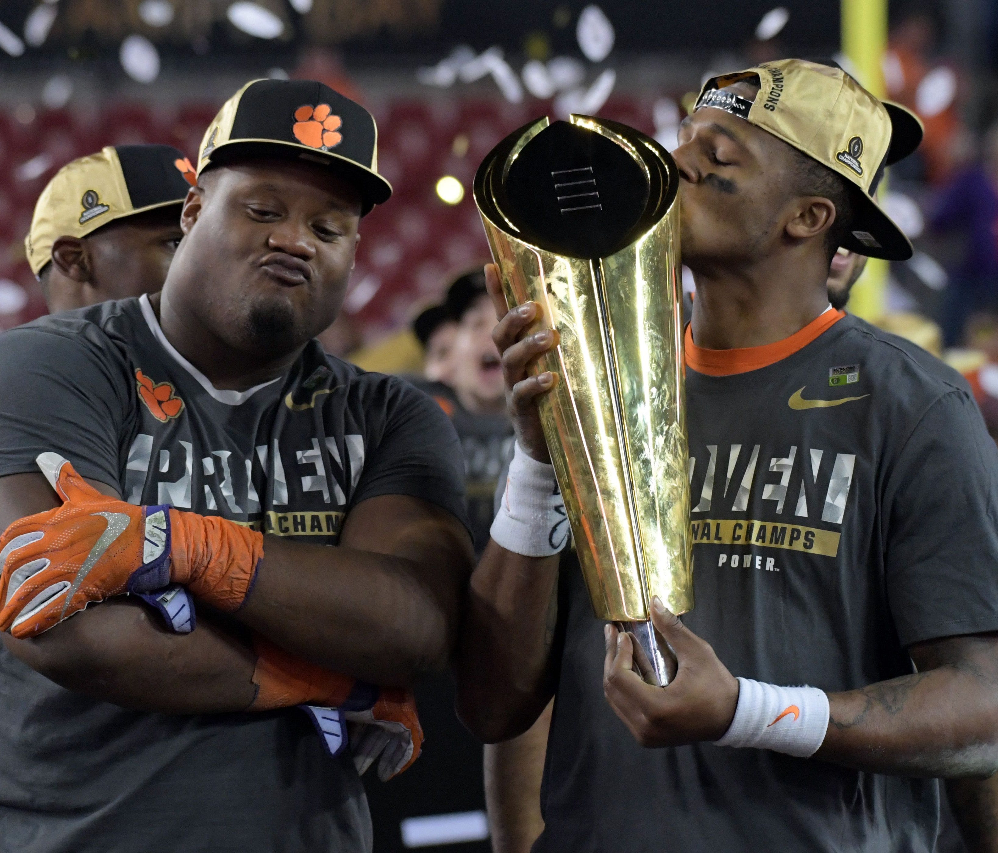 Clemson quarterback Deshaun Watson celebrates with the national championship trophy after beating Alabama in the 2016 College Football Playoff title game.