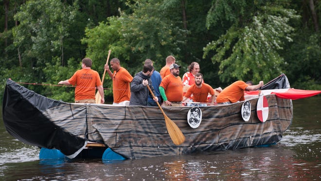 In this 2015 photo, the Battle Creek Metropolitan Area Mustache Society floats down the Kalamazoo River as part of the Up the Creek Raft Race.