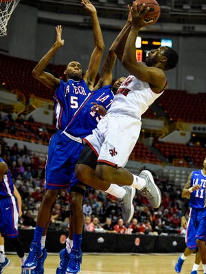 UL's Johnathan Stove (22) goes up for a shot against Louisiana Tech guard Jacobi Boykins (13) during the first half of a 2014 NCAA men's basketball game at the Cajundome.
